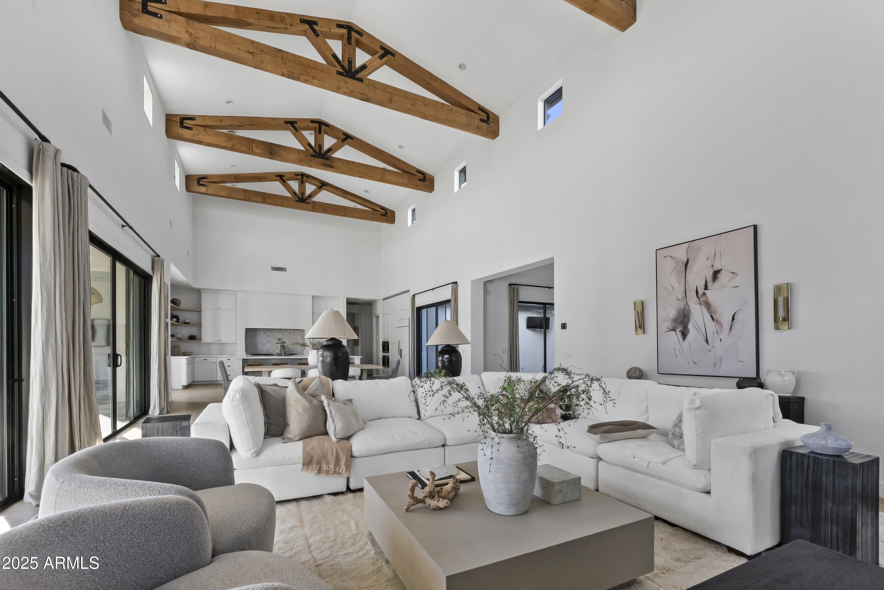 a living room with furniture a rug and a chandelier