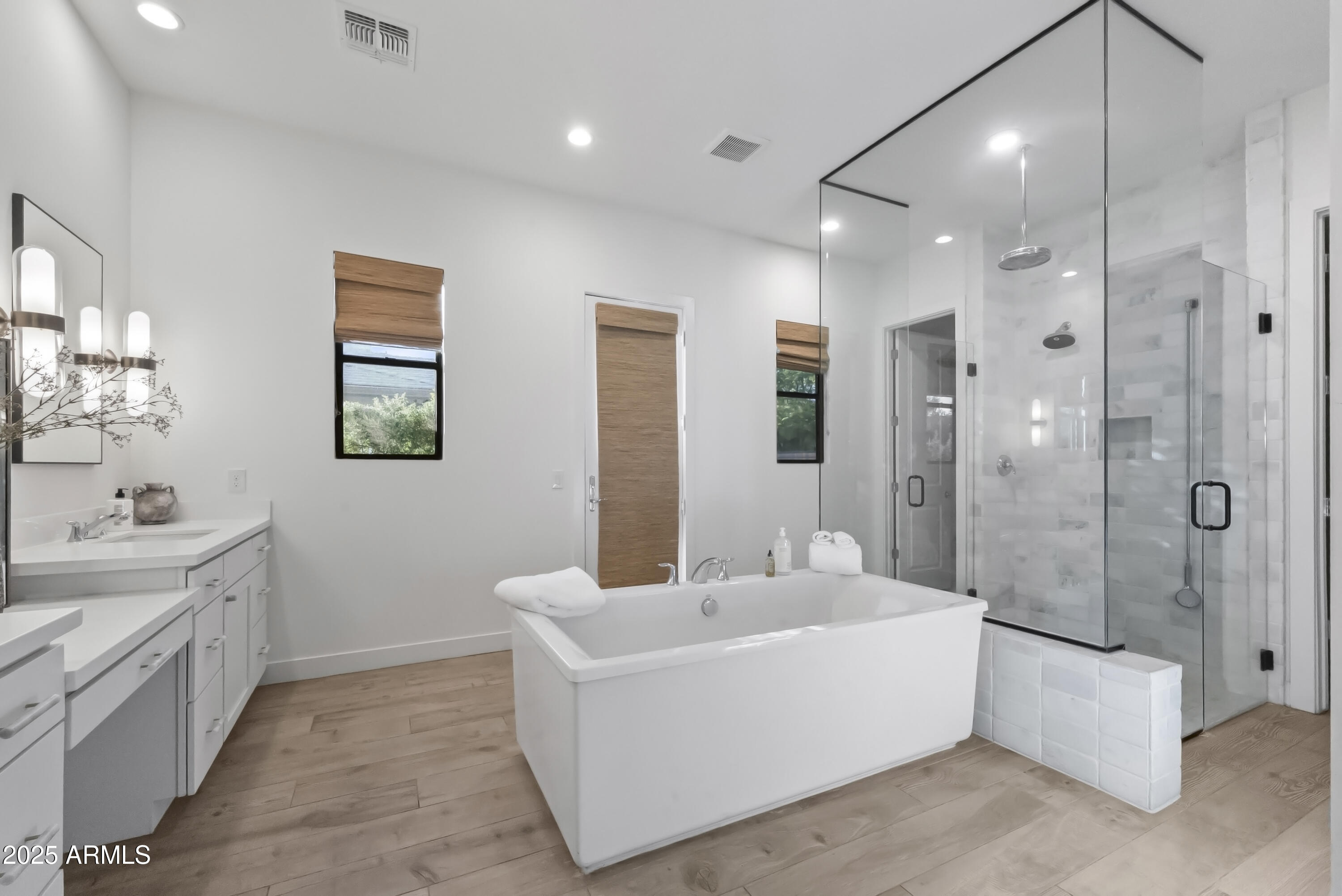 2753 East Hummingbird Way Gilbert, AZ 85297 - Photo 18 of 44 a bathroom with a double vanity sink a large mirror a shower and bathtub