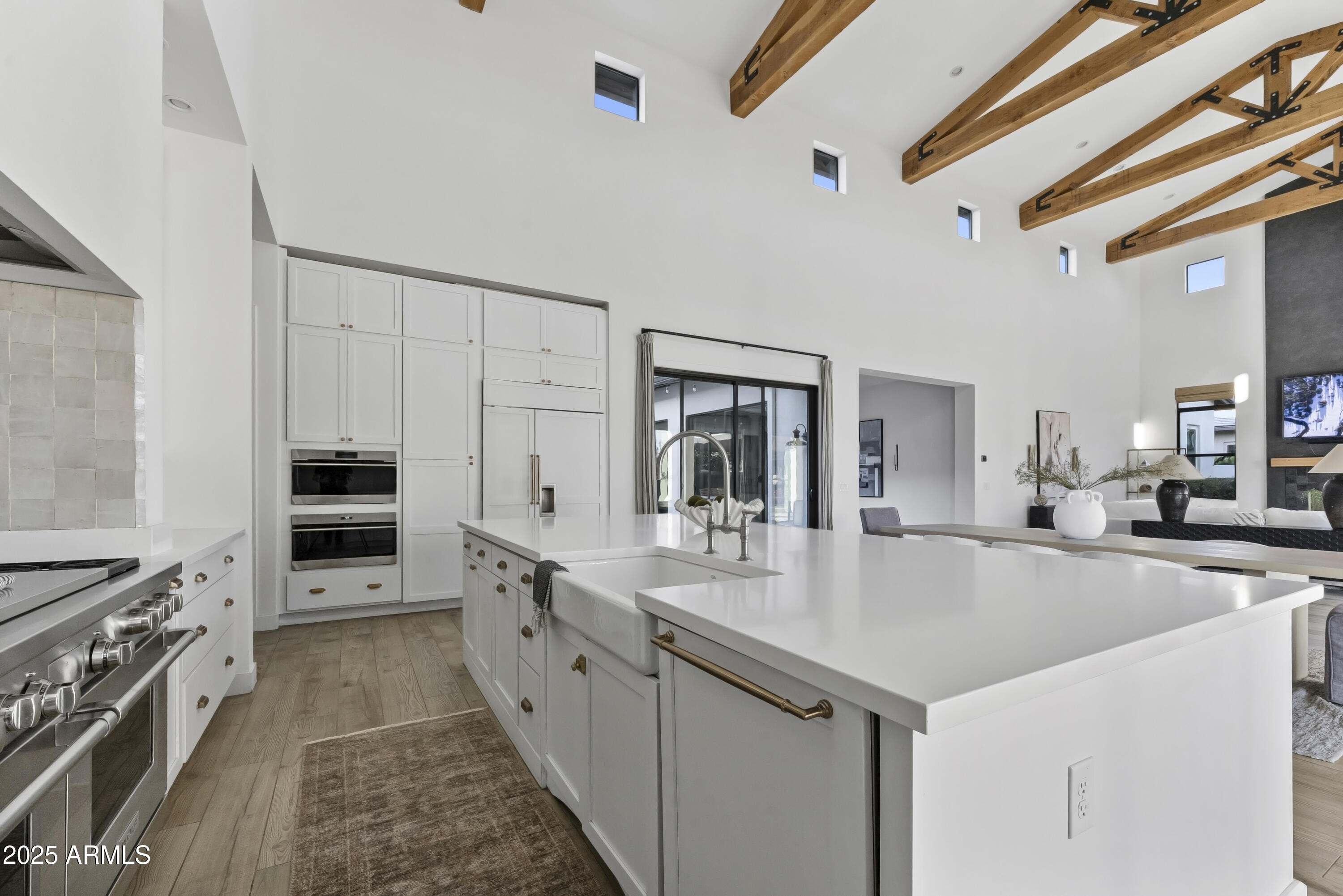 2753 East Hummingbird Way Gilbert, AZ 85297 - Photo 2 of 44 a large kitchen with granite countertop a large counter top space appliances and cabinets