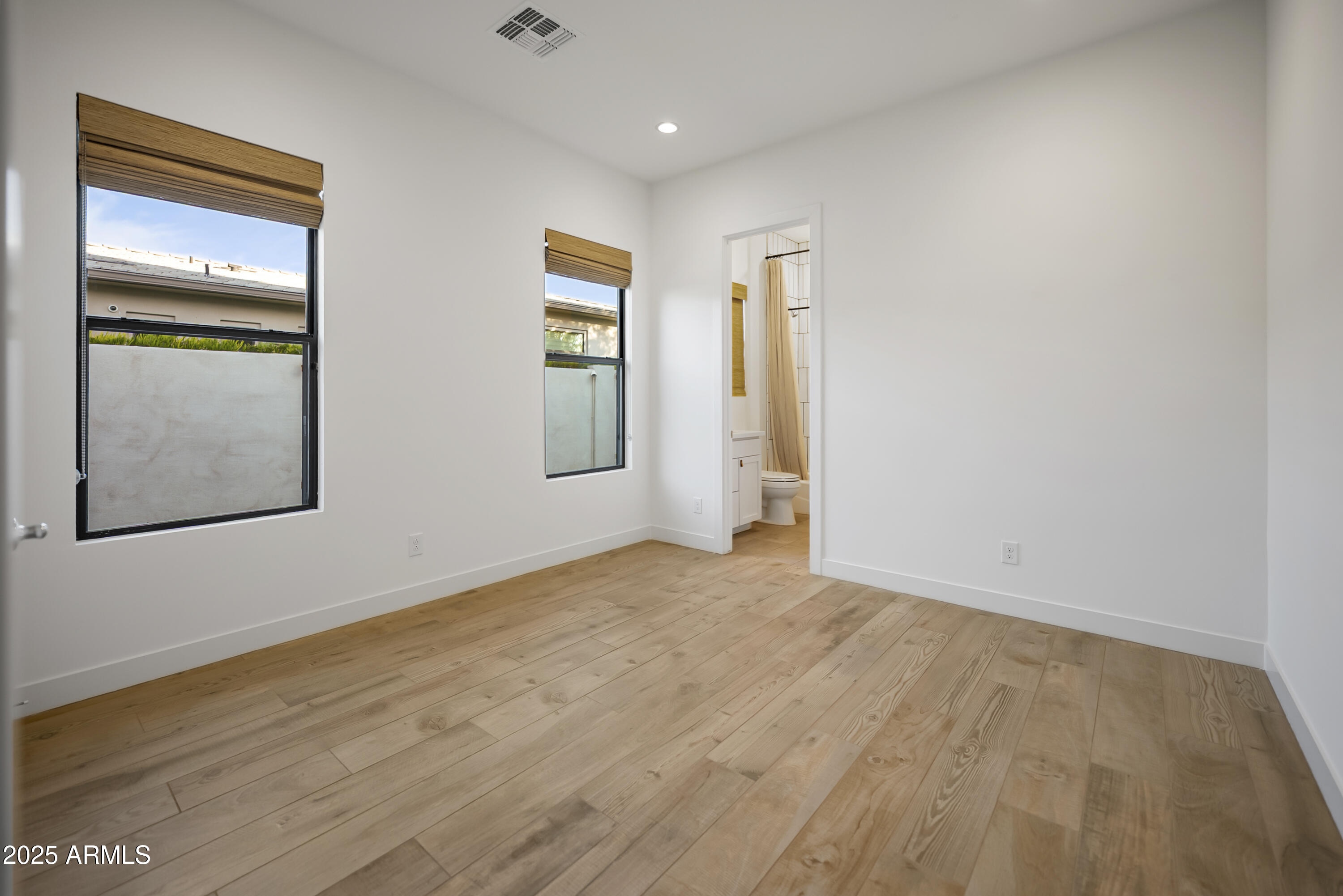 2753 East Hummingbird Way Gilbert, AZ 85297 - Photo 29 of 44 a view of an empty room with window and wooden floor