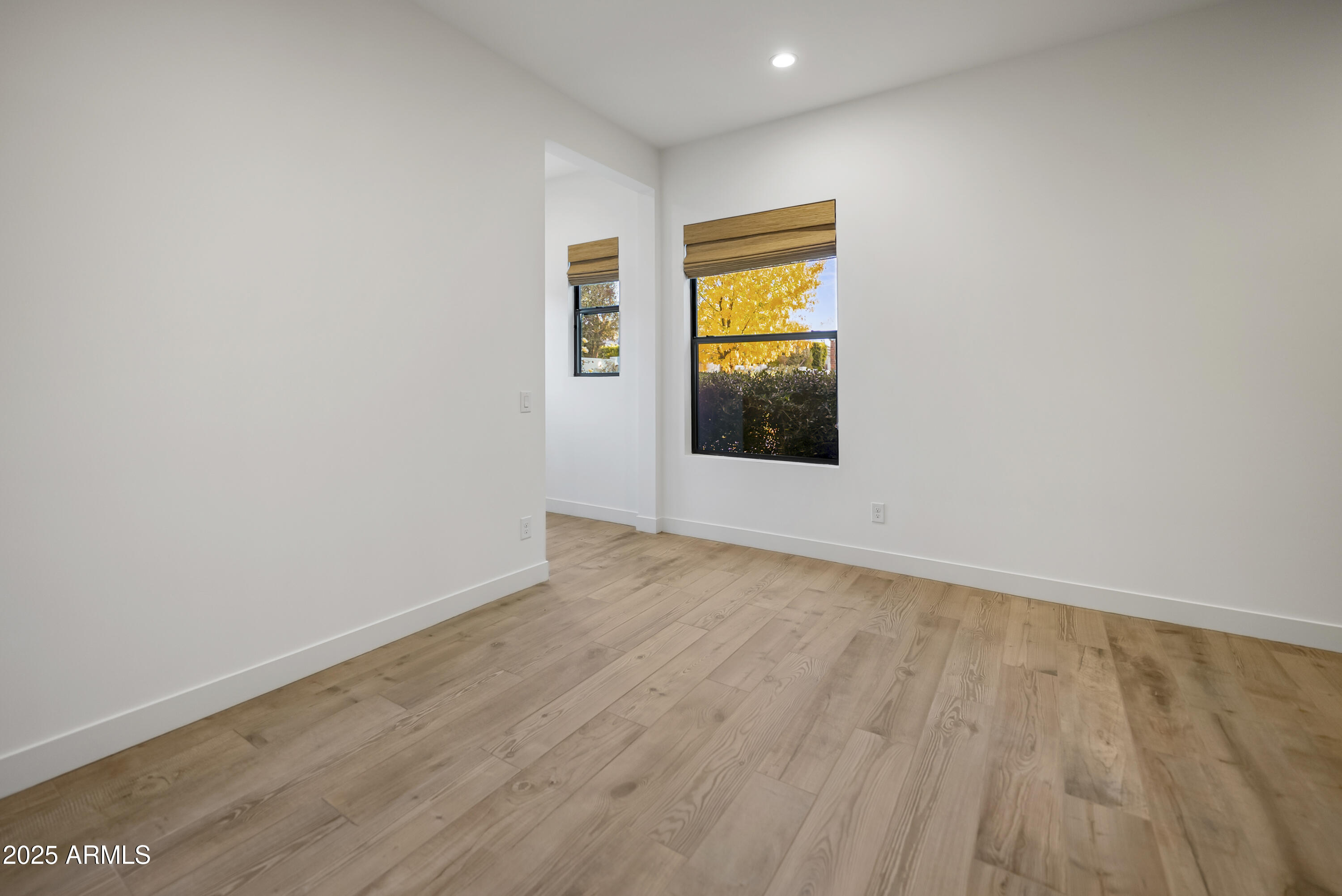 2753 East Hummingbird Way Gilbert, AZ 85297 - Photo 33 of 44 a view of an empty room with wooden floor and a window