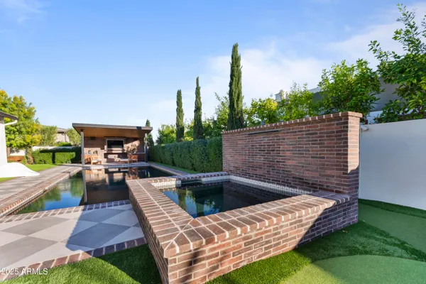 a view of outdoor sitting area with furniture and garden