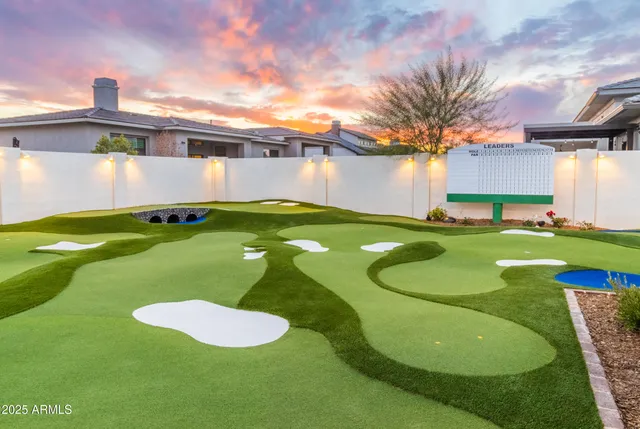 a living room with stainless steel appliances furniture cabinets and a rug