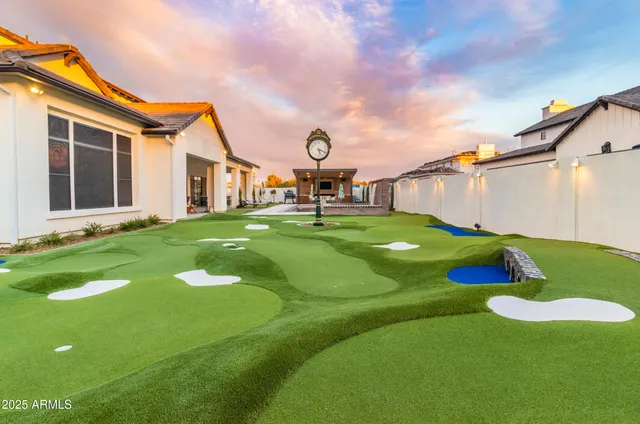 a open kitchen with stainless steel appliances a stove a sink dishwasher and white cabinets with wooden floor