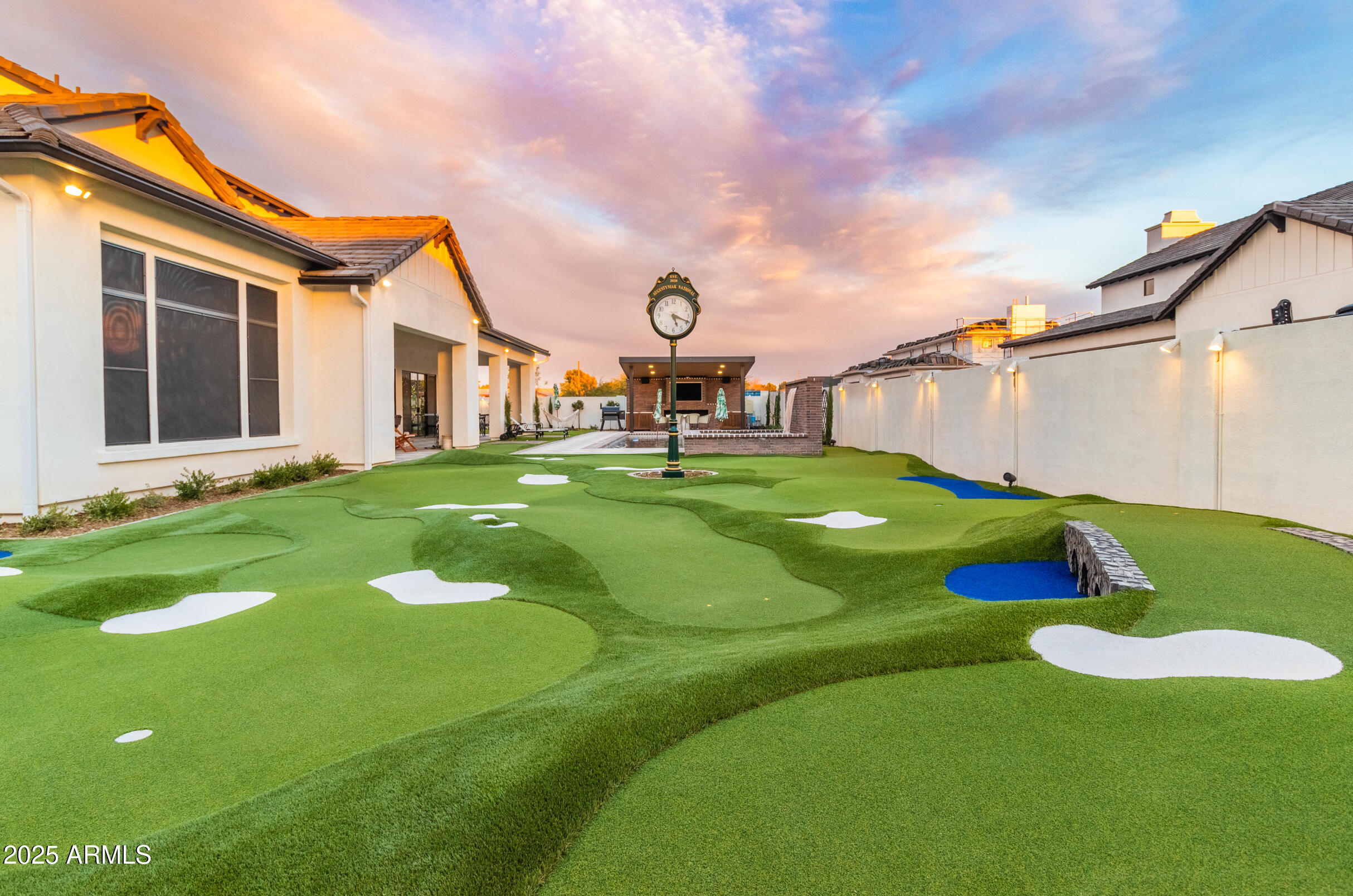 2753 East Hummingbird Way Gilbert, AZ 85297 - Photo 6 of 44 a swimming pool with some trees in the background