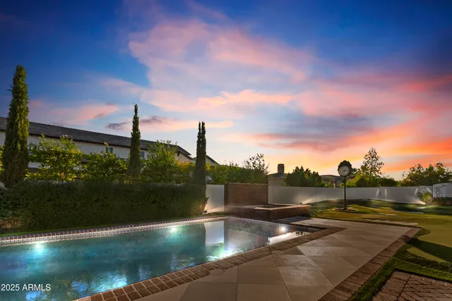 a bathroom with a double vanity sink a large mirror a shower and bathtub