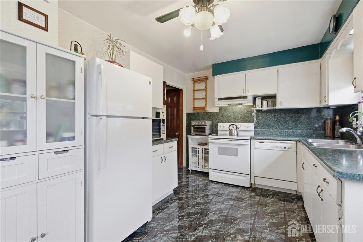 33 Ellison Road Somerset, NJ 08873 - Photo 10 of 38 a kitchen with white cabinets and white appliances