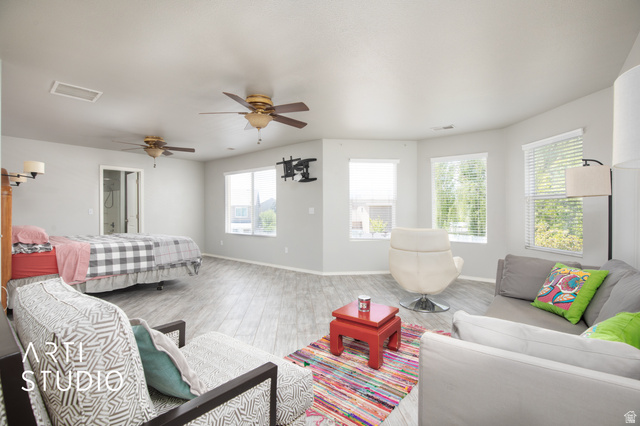 342 South Willow Patch Road Lehi, UT 84043 - Photo 23 of 30 Spacious interior featuring wood-finish flooring, multiple windows with blinds, and two ceiling fans
