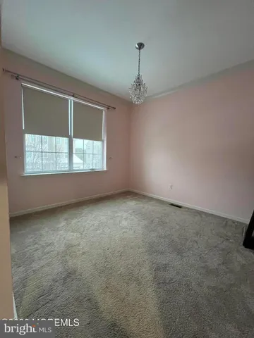 an empty room with a empty space and windows