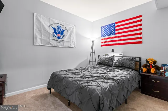 a bedroom with a bed and a painting on the wall