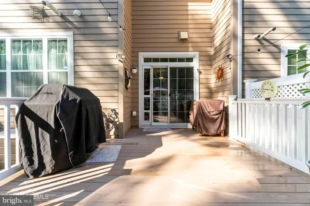a view of a patio with table and chairs and wooden floor