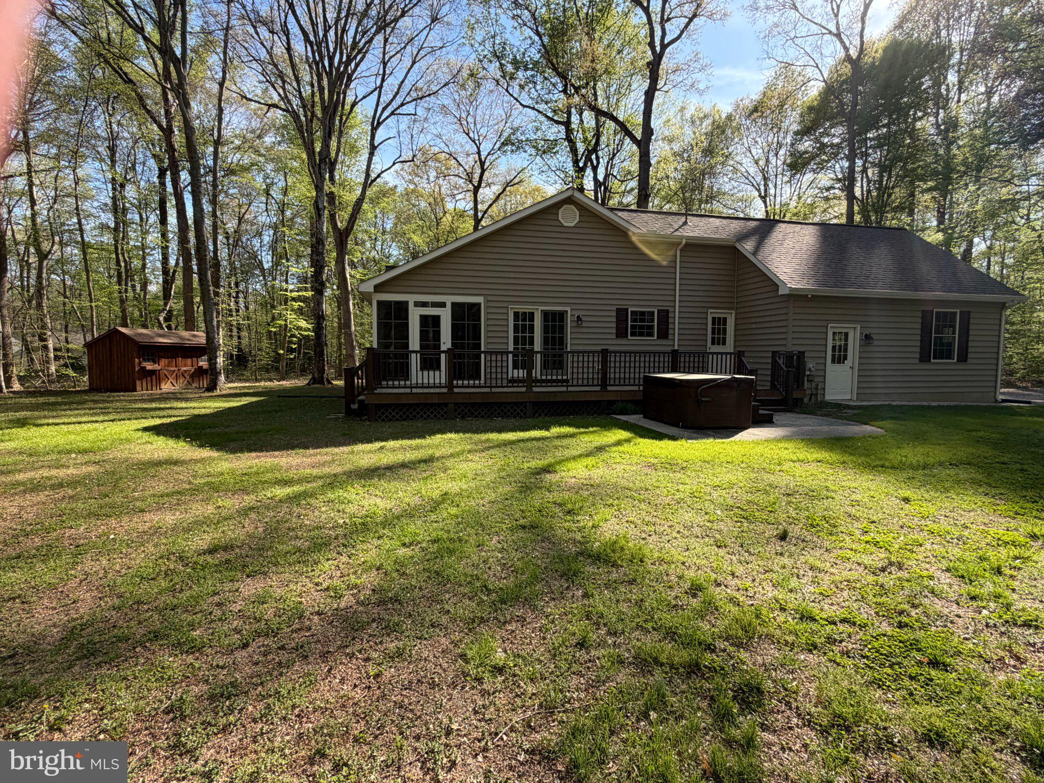 8664 Mitchell Road Denton, MD 21629 - Photo 21 of 22 a view of a house with a big yard and large trees
