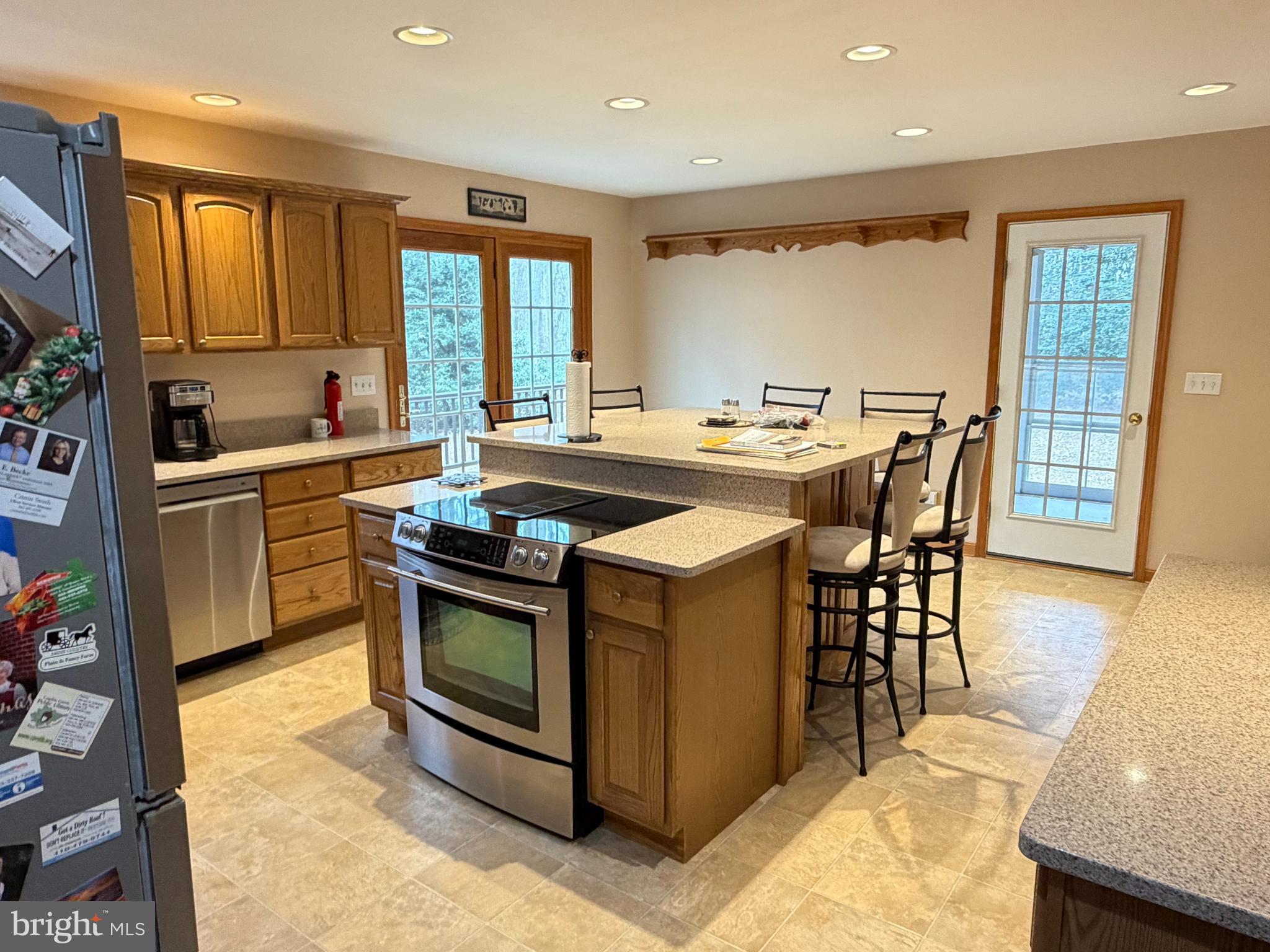 8664 Mitchell Road Denton, MD 21629 - Photo 9 of 22 a kitchen with a stove a sink a dining table and chairs