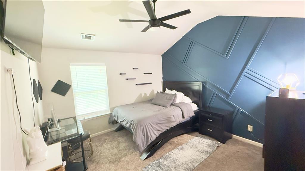 3370 Elkhorn Ridge Run Dacula, GA 30019 - Photo 22 of 29 a bedroom with a bed and a chandelier