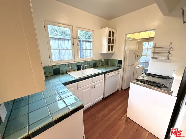 a kitchen with stainless steel appliances a sink stove and cabinets