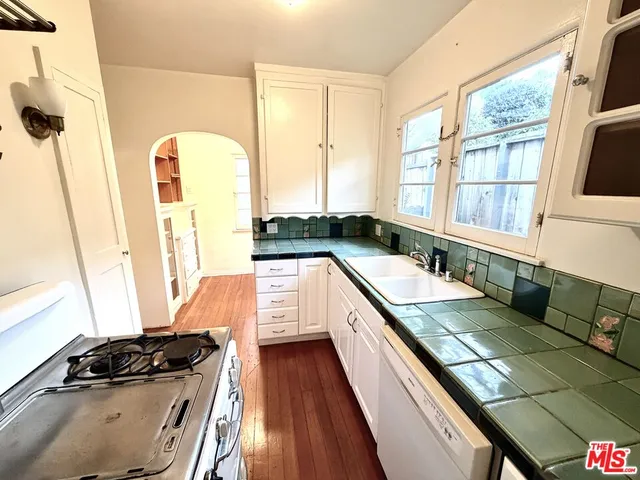 a kitchen with a sink a counter top space and a large window