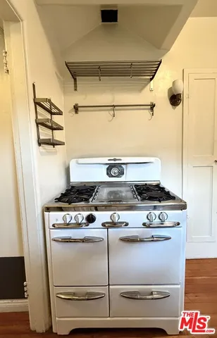 a stove top oven sitting inside of a kitchen