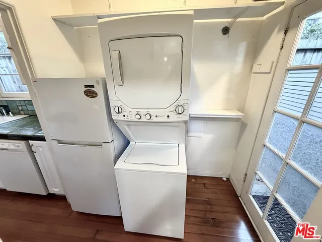a view of a kitchen with wooden floor and cabinets