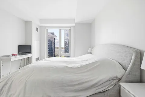 a bedroom with a bed and a flat screen tv