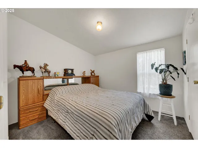 a bedroom with a bed and a table