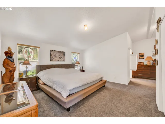 a bed room with a bed and a view of living room