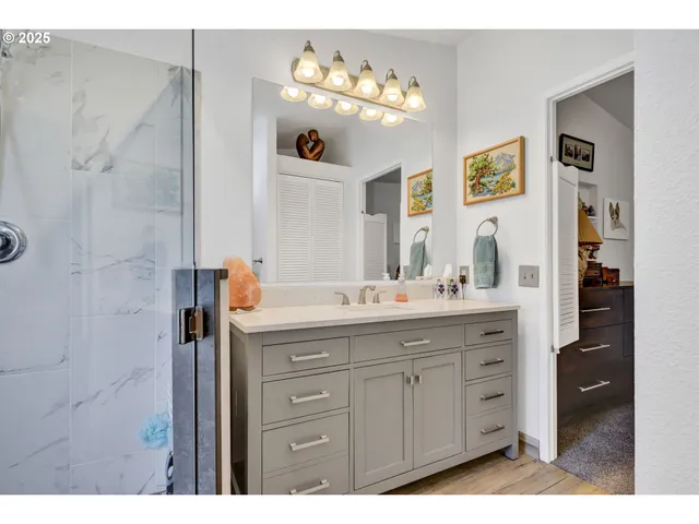 a bathroom with a sink vanity and mirror