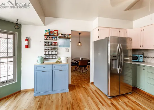 a kitchen with stainless steel appliances a refrigerator and a stove top oven