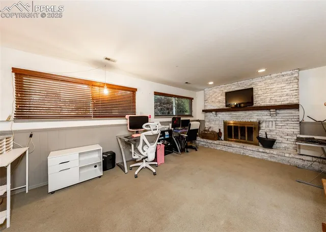 a view of a livingroom with furniture and a fireplace