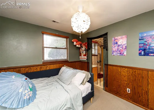 a bedroom with natural light and a bed