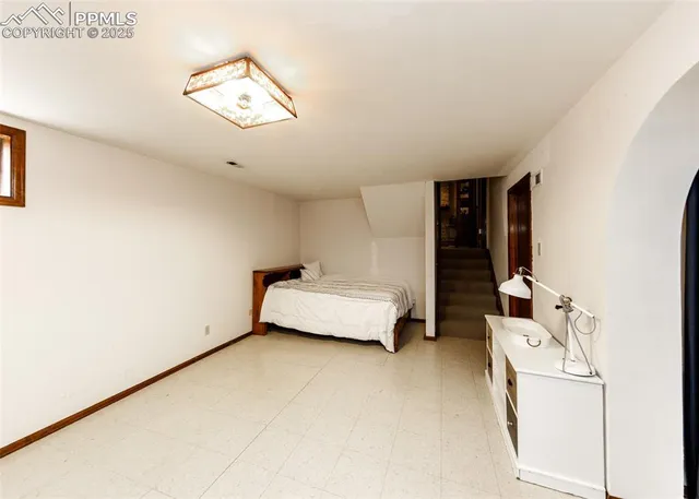 a bedroom with a bed and a chandelier