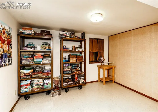 a view of a room with racks book shelf