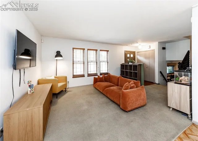 a bedroom with furniture and a flat screen tv