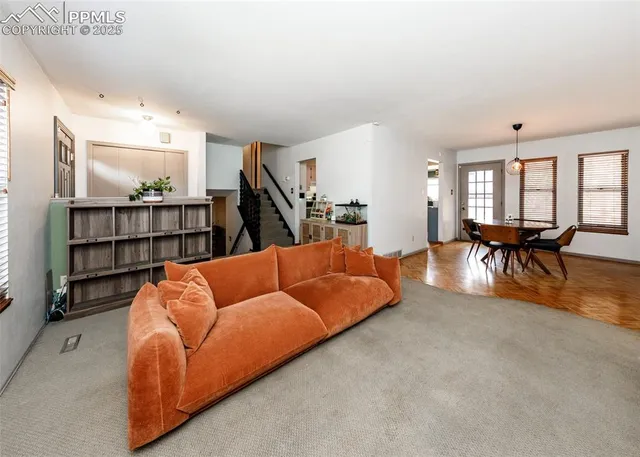 a living room with furniture a dining table and a flat screen tv