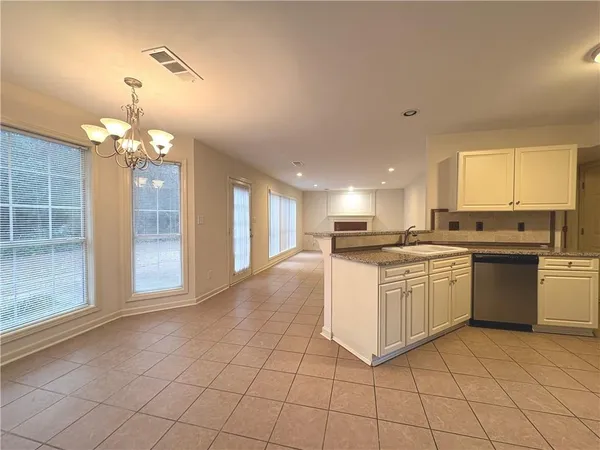 a kitchen with stainless steel appliances granite countertop a sink and cabinets