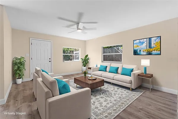 a living room with furniture and a potted plant