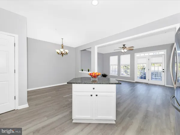 a kitchen with refrigerator and cabinets