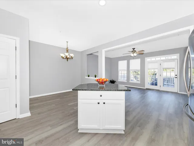a kitchen with refrigerator and cabinets