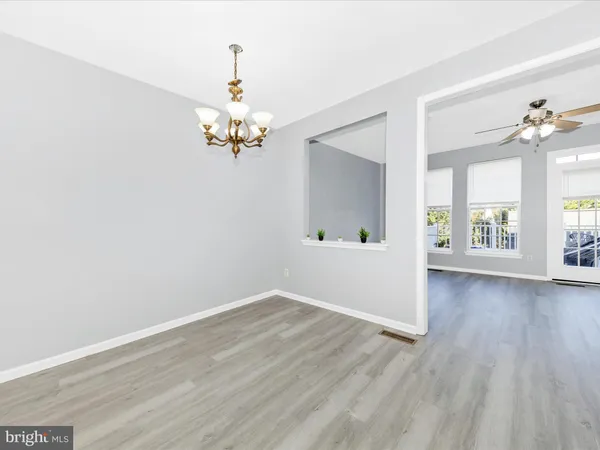 a view of kitchen with cabinets and wooden floor