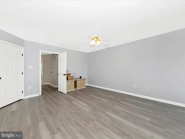 a spacious bathroom with a tub sink and mirror