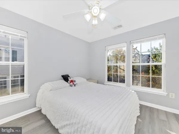 a bedroom with a bed and a large window with outer view
