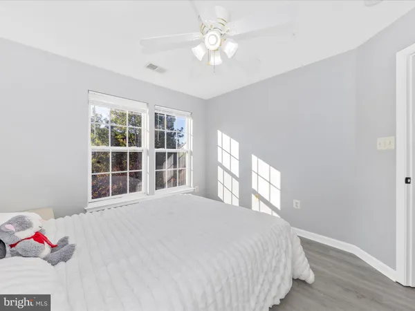 a spacious bedroom with a bed and a chandelier