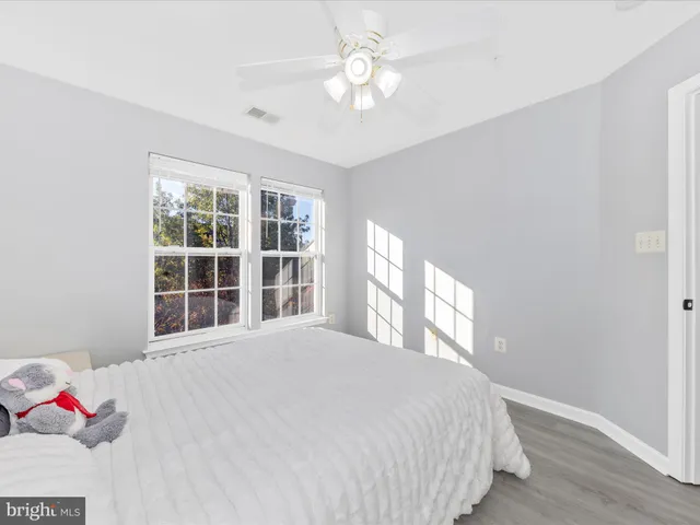 a spacious bedroom with a bed and a chandelier