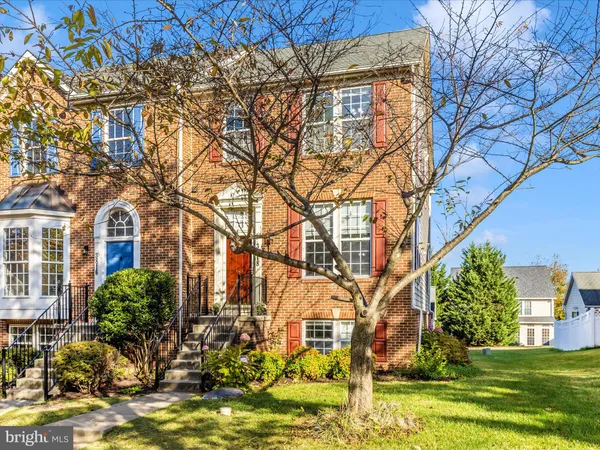 a front view of a brick house with a yard