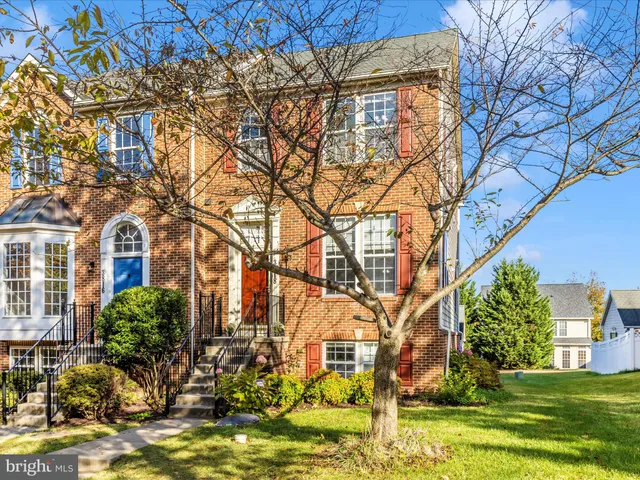 a front view of a brick house with a yard