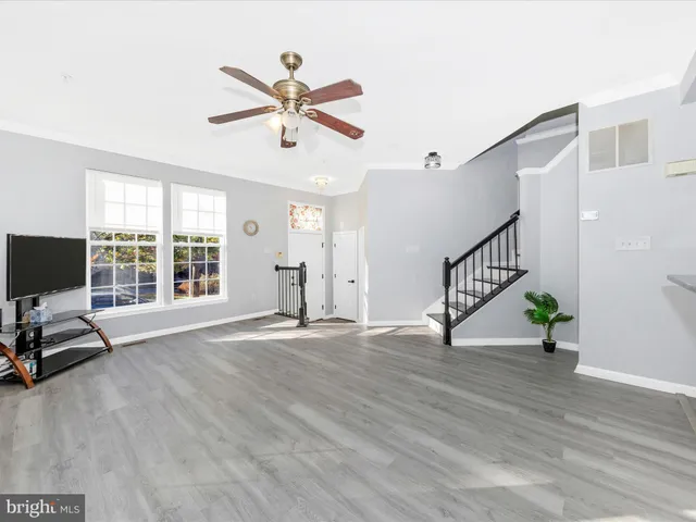 a view of livingroom with hardwood floor and a ceiling fan