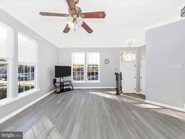 a view of livingroom with hardwood floor and a ceiling fan
