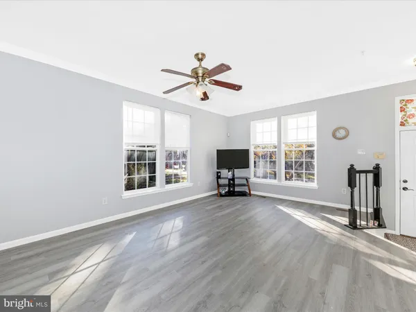 a view of a livingroom with a ceiling fan and a window
