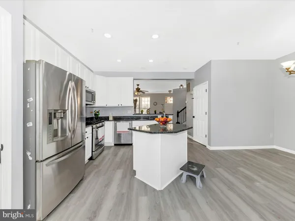 a kitchen with a refrigerator a sink and dishwasher a refrigerator with wooden floor