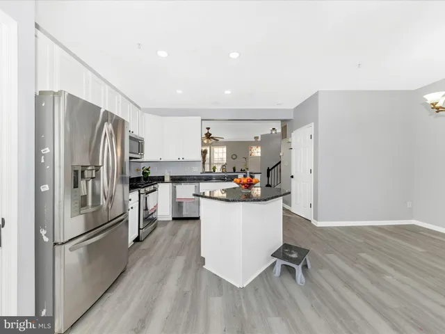 a kitchen with a refrigerator a sink and dishwasher a refrigerator with wooden floor