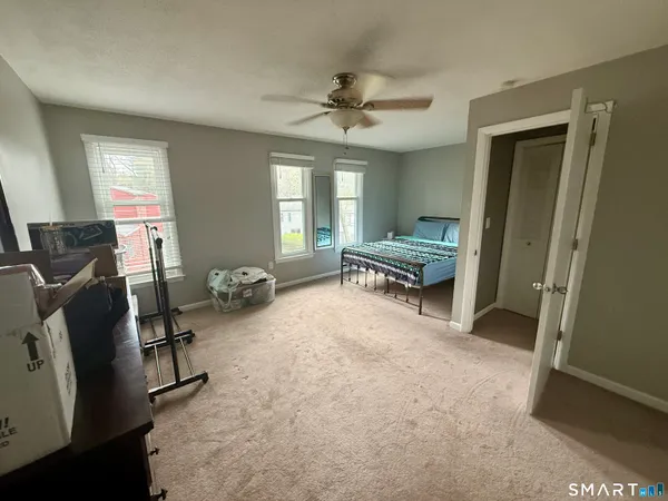 a bedroom with furniture and a window